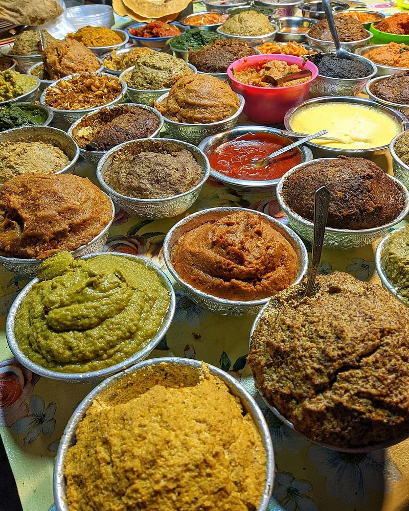 Dozens of colorful Bangladeshi vortas in bowls at a vorta festival